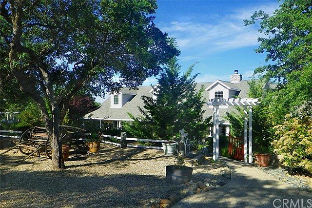 Front view of house and gated path leading to front door.
