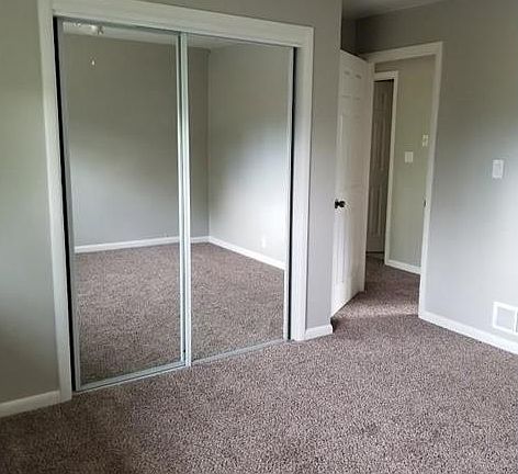 master bedroom with ceiling fan, new windows, and new carpet.