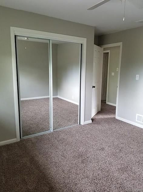 master bedroom with ceiling fan, new windows, and new carpet.