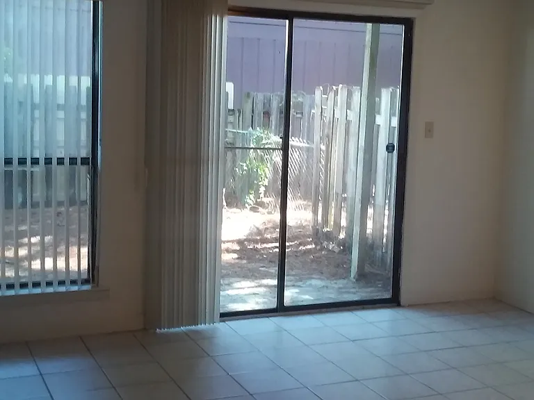 Living room area with sliding door leading to privacy fenced yard