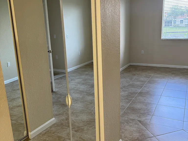 The large master bedroom has walk-in double closets with full length mirrors.