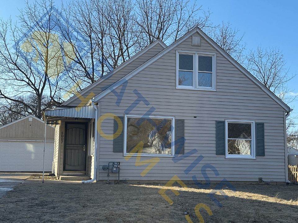 Front of home with large driveway and 2 car garage