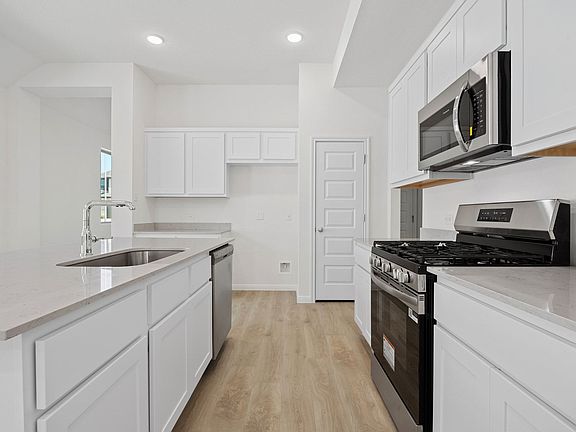 Kitchen in the Elm home plan by Trophy Signature Homes - REPRESENTATIVE PHOTO
