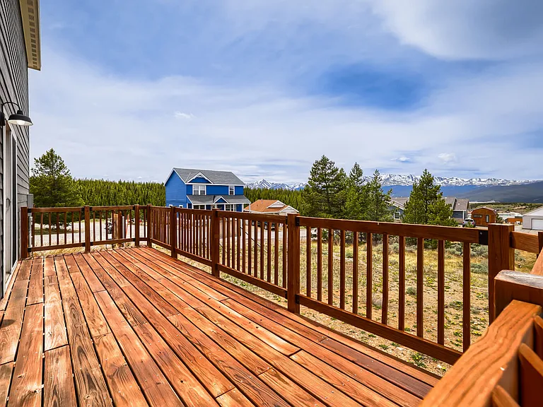 West facing deck with mountain views, accessed through sliding doors in dining area