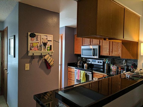 Kitchen with granite counter top, steel appliances
