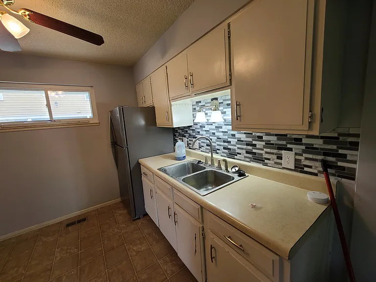 This photo is from when this unit was rented in 2021. This kitchen will be getting solid stone counter tops once the renters vacate.