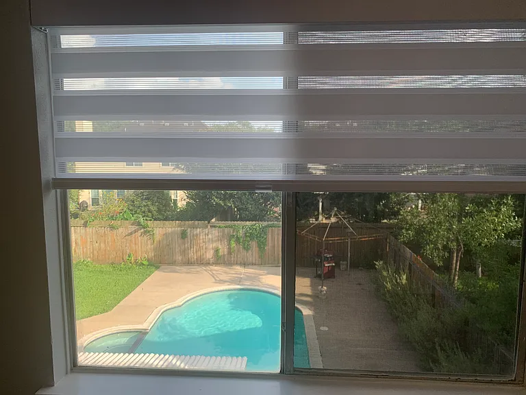10. Secondary bedroom overlooking the backyard and the pool