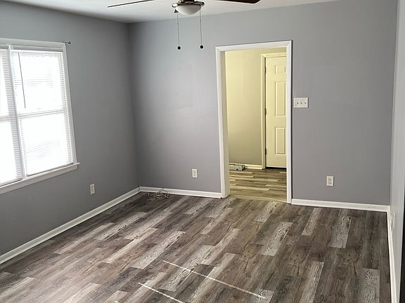 Bright Living room area that leads to the enclose front porch area.
