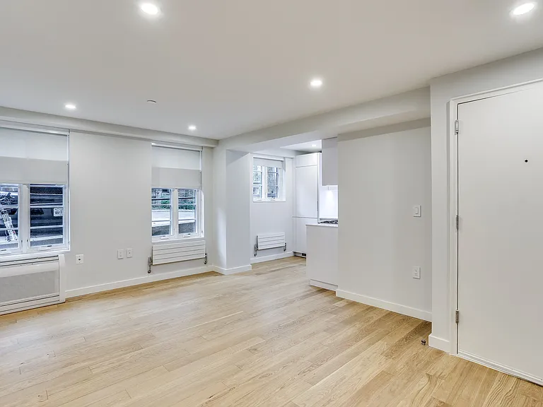Unit 102, open living room with hardwood floors