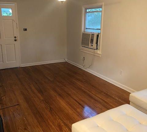 Large main bright and sunny living space with brand new finished hardwood floors.