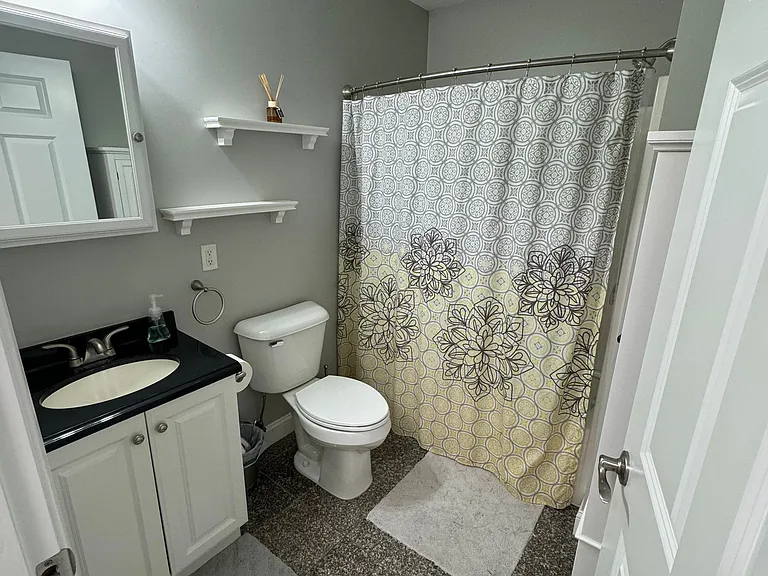 Full bath with granite tile flooring
