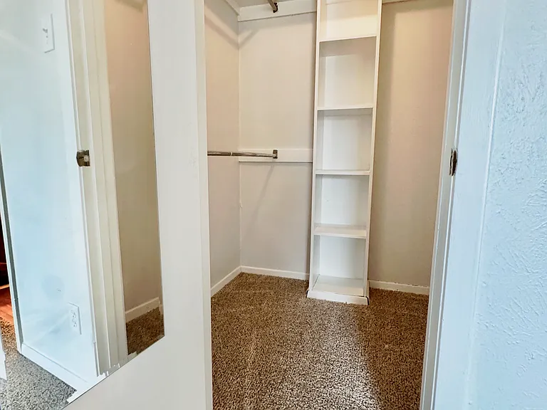 walk in closet in primary bedroom
