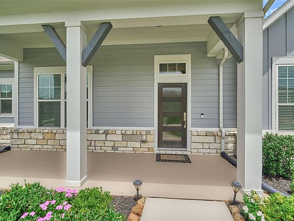 The large front porch with stone accents and contemporary door to greet you as you enter. You have the Ring Doorbell for additional security.