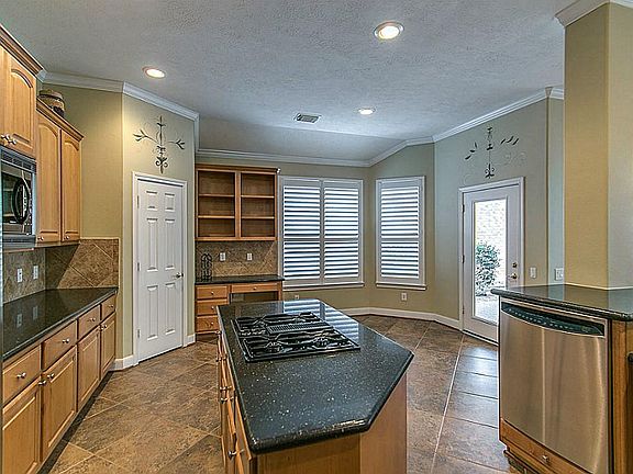 Spacious Island Kitchen with Gas cook top, stainless steel double ovens and built-in microwave.  Enjoy the built-in desk space and shelving near the Breakfast Room as an extra perk of this great kitchen!