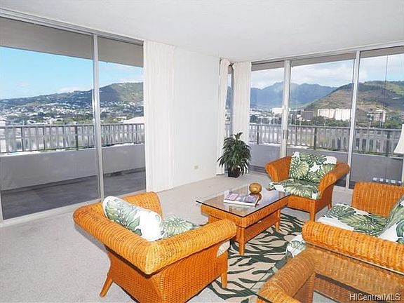The living room features a wrap-around lanai with gorgeous views of Manoa Valley, Honolulu city views, and sunset views overlooking Punchbowl.