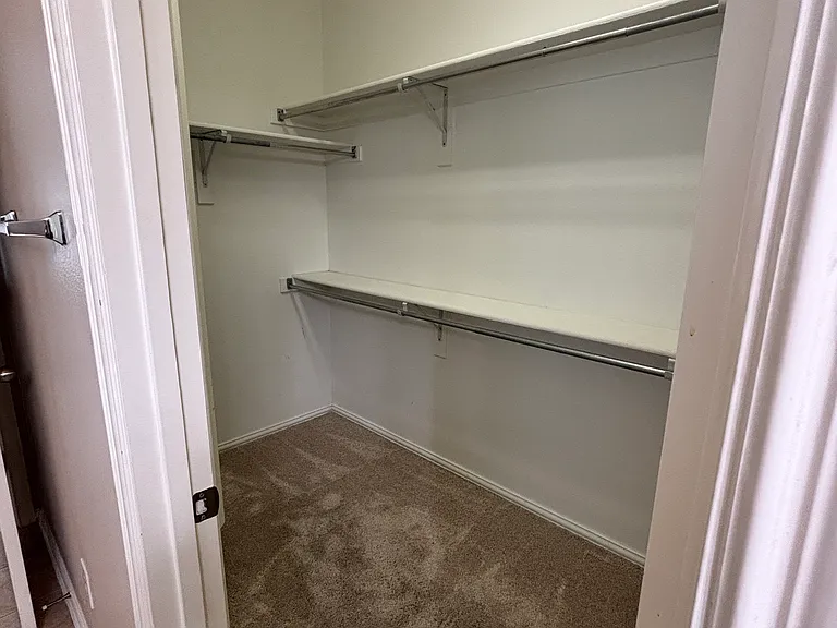 Master Closet 11.5'x5'. Double Racks and Build in Shelves. Matching Wood look tile will be installed 7/2026.