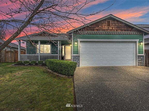 Glows like a beautiful lantern.  Exterior features include a covered front patio with seating area and Ring Doorbell, cement backed siding with cedar and stone accents. Garage doors are insulated!