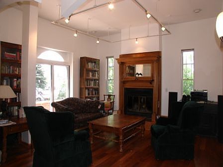 Living Room 21'x15' w/ woodburning fp, 100 yr old mantle, and copper top bar