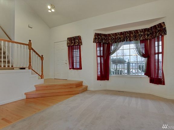 Entry with vaulted ceiling and oak hardwood flooring