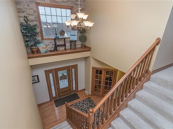 A stacked stone wall adds rustic elegance to this display ledge located in the foyer.