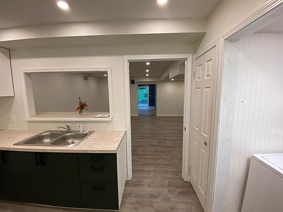 Looking from kitchen through the living room towards the entrance