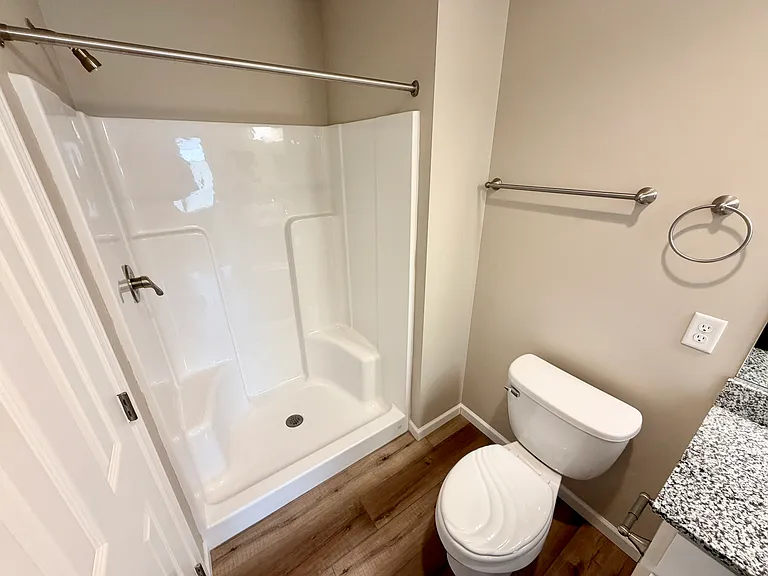 View of shower and linen closet in primary bathroom