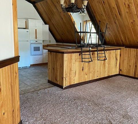 Sit at bar to the kitchen.