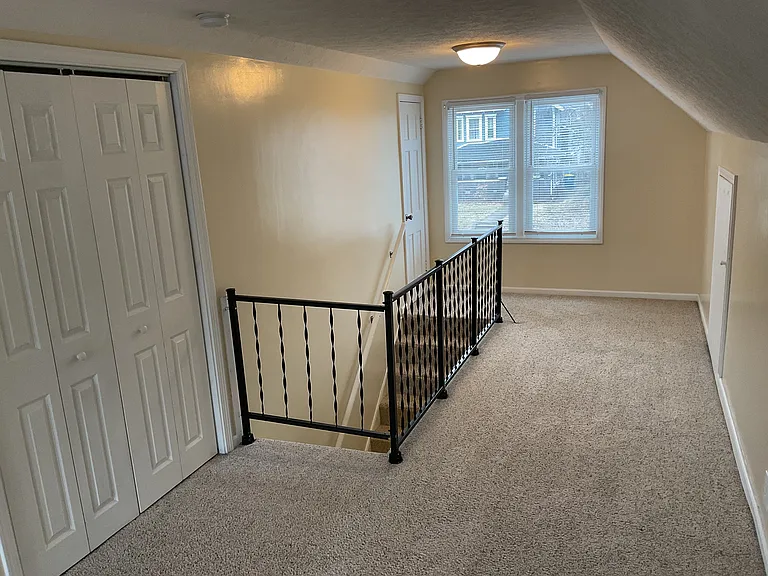 Upper Bedroom with Carpet and two Closets.