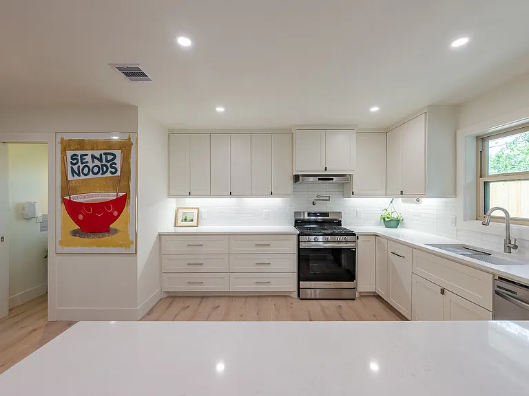 Functional kitchen with ample cabinetry, 5 burner gas range, generous counter space, and thoughtful layout for everyday convenience.
