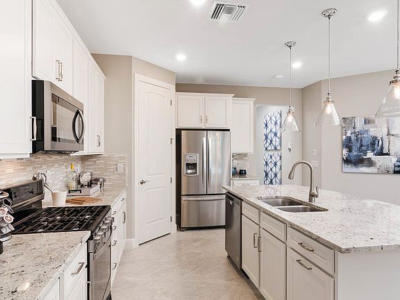 Model Representation Well-appointed kitchen with stainless steel gas appliances