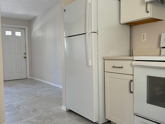 Open kitchen with door to backyard