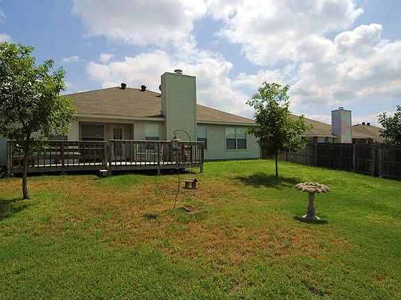 Nice backyard with wood deck.