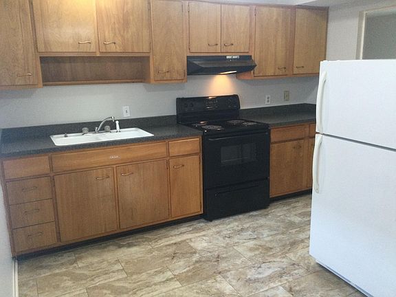 Kitchen with new refrigerator, new stainless hood and electric range.