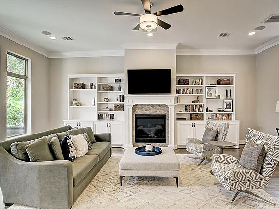 First floor living room has 2 Â¼â wide white oak hardwood floors, 11 ft ceiling with recessed lighting, custom crown moulding, double pane vinyl windows, built-in bookcases, and a craftsman style gas fireplace.