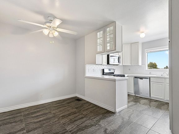 Chefs kitchen with newer stainless appliances(range, microwave, dishwasher, refrigerator) and views overlooking Los Angeles