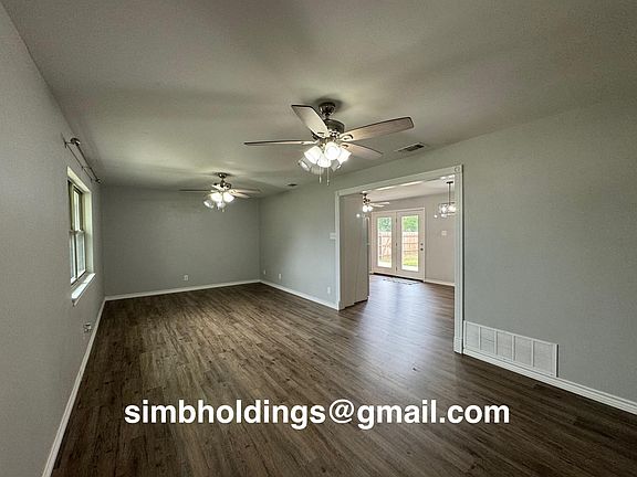 Large living room with views into the kitchen, dining area and even the backyard