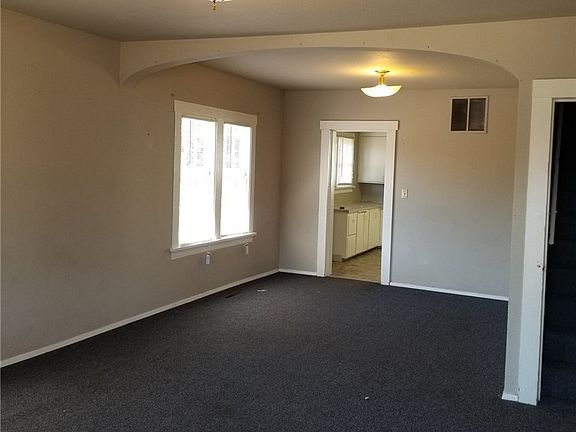 View of the living room as you enter front door.  Door on right goes upstairs.  Further right is one of the bedrooms
