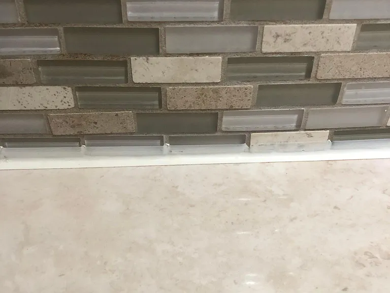 Main bath with modern marble vanity top and custom tile.