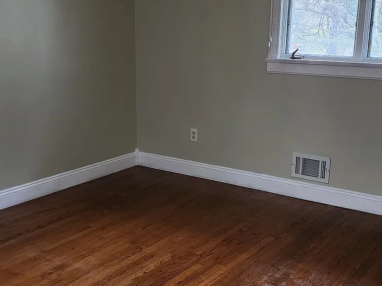 Bedroom 2 has siding closet with installed closet organization. There is a front double window and a side window in this room.