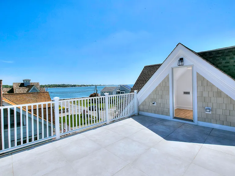 Roof deck with panoramic harbor and marshland views.