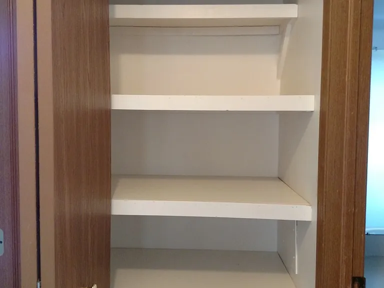 Linen closet at end of hallway.