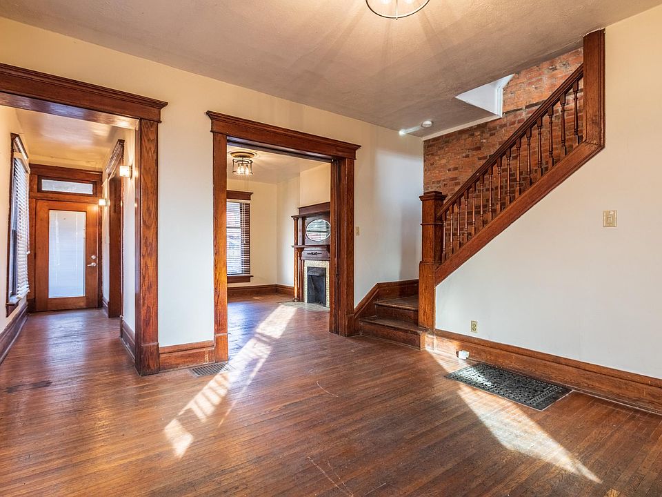 Two first-floor rooms. A living room and dining room. The kitchen is behind. Actual real hardwood in the apartment.