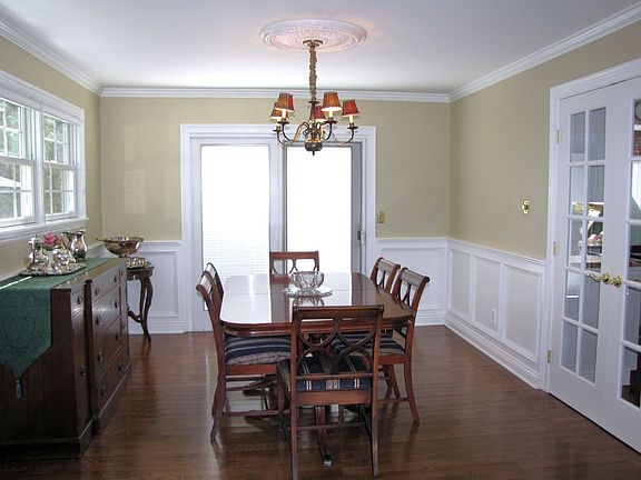 dining room: wood floors, wainscoting,French doors to kit, opens to pool