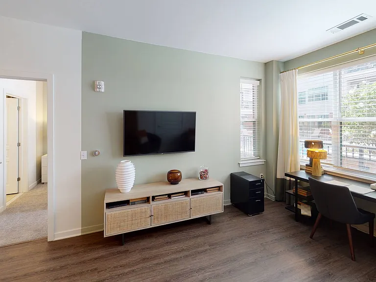 Natural light pours in through the living area's open windows