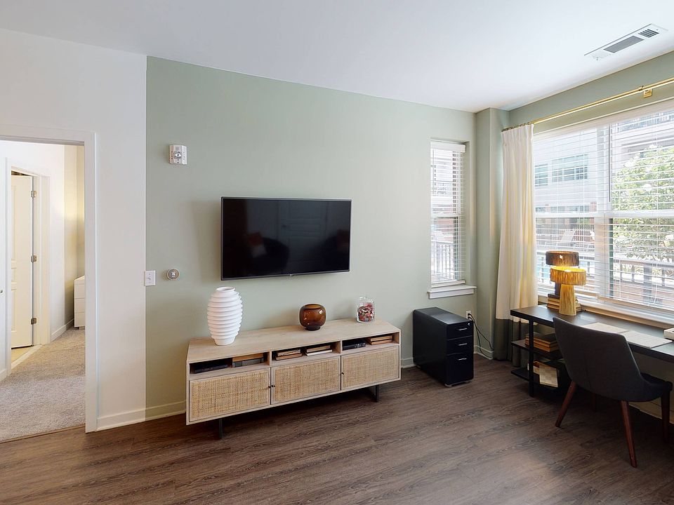 Natural light pours in through the living area's open windows
