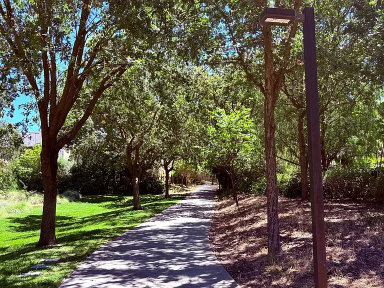 Peaceful shaded greenbelt trail for biking and walking to nearby schools
