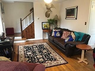 The living room has great light and a ceiling fan. Wired for internet