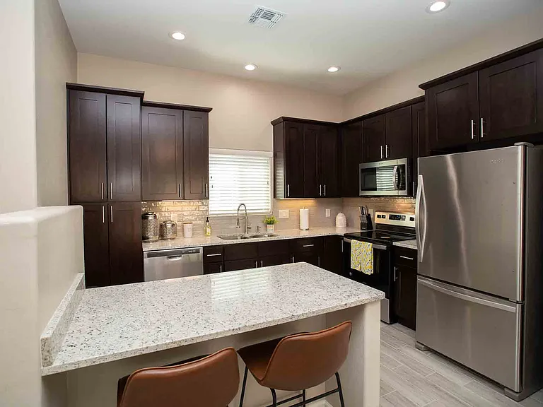 Kitchen with granite counter tops, breakfast nook, stainless steel appliances and 42 inch upper cabinets.