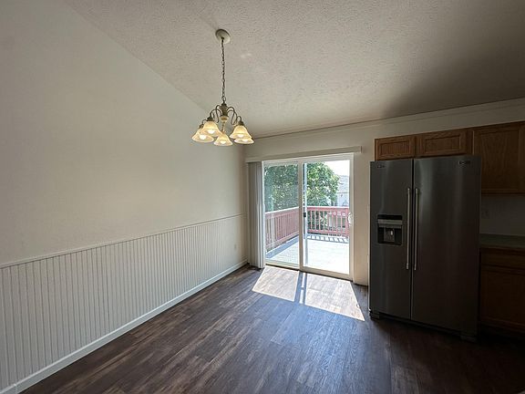 Dining area with brand new sliding door to the back deck.