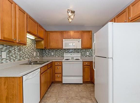 Upgraded cabinets, tile backsplash, newer floors and appliances, and solid counter tops in the kitchen.